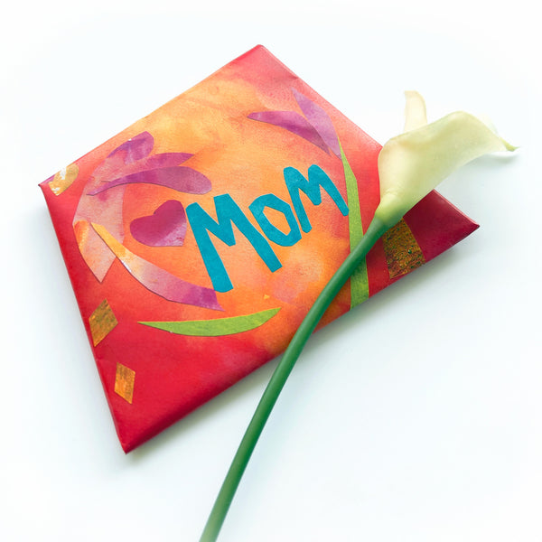 Colorful envelope with 'MOM' and a calla lily on a white background.